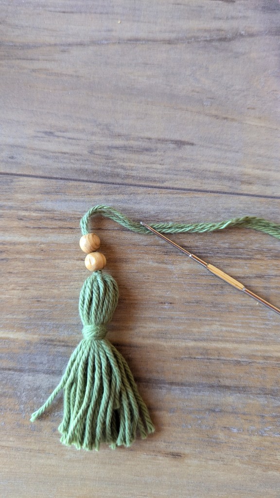 Using a small crochet hook I threaded on a couple of wooden beads.
